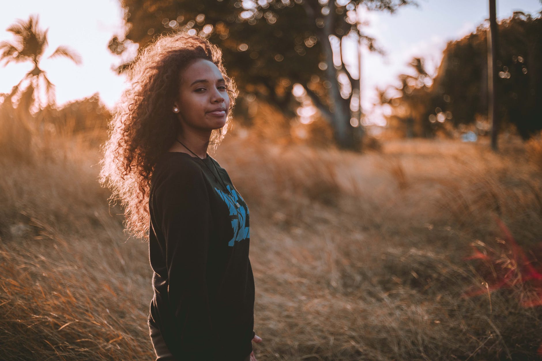 woman wearing black sweater standing on the field