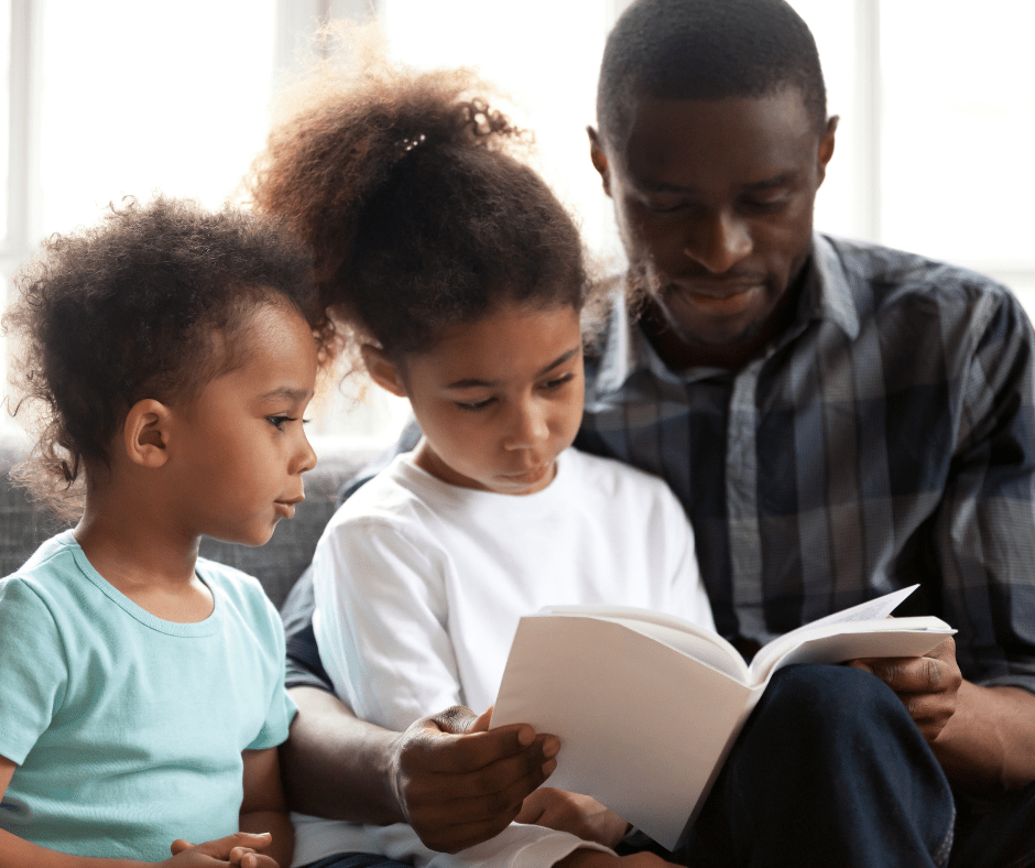 Father reading to his daughters